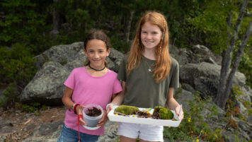 Girls holding plants.