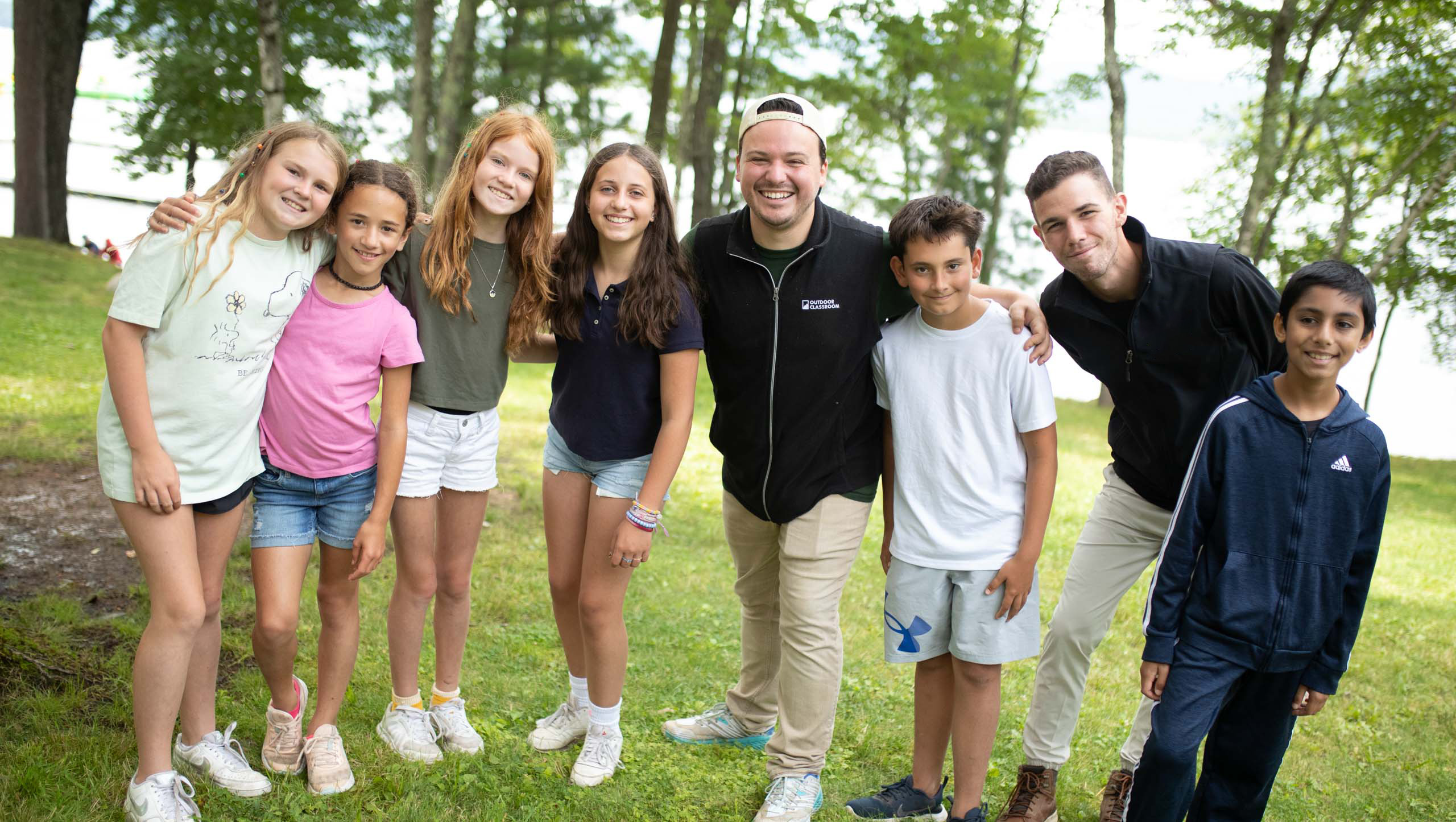 Group of kids posing with staff.